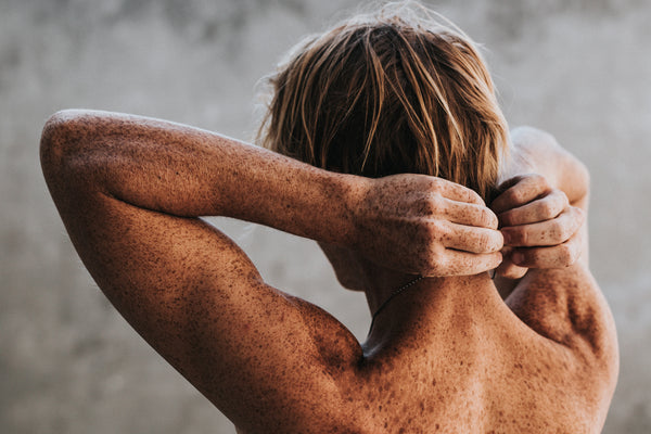 Red haired woman eating a coconut